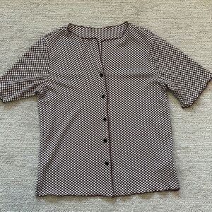Woman’s brown and white checkered shirt.